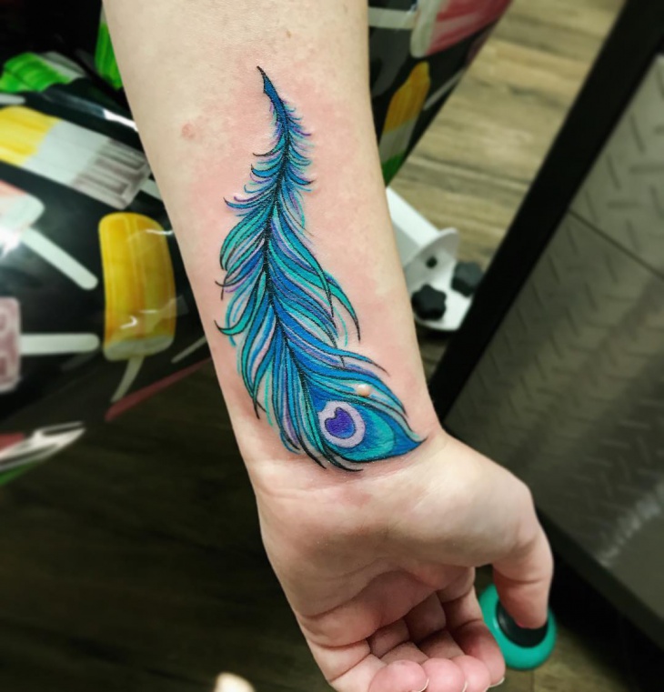peacock feather wrist tattoo