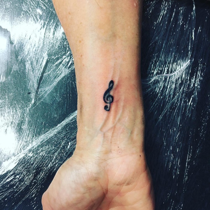 small music wrist tattoo for men
