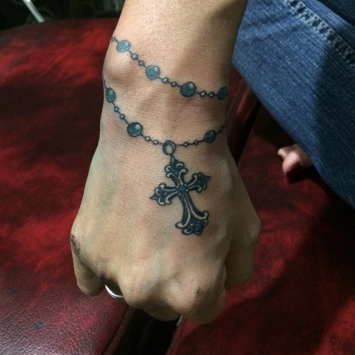 cross band tattoo on hand