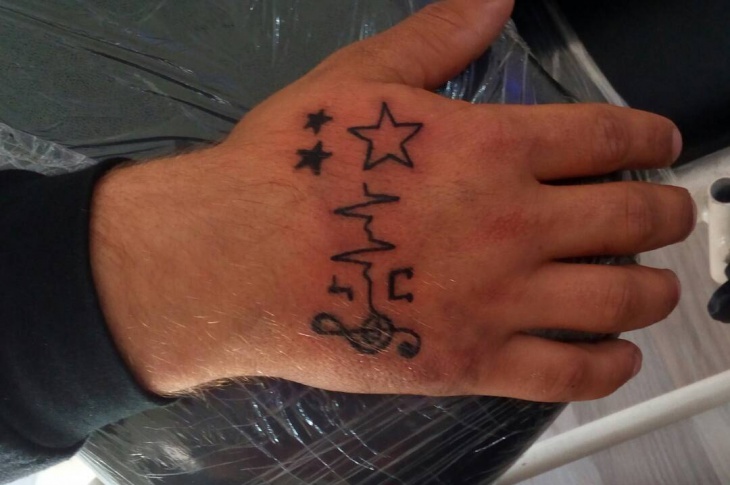 music sign tattoo on hand