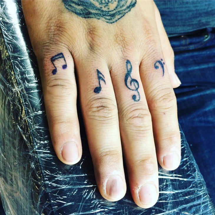 music notes tattoo on hand