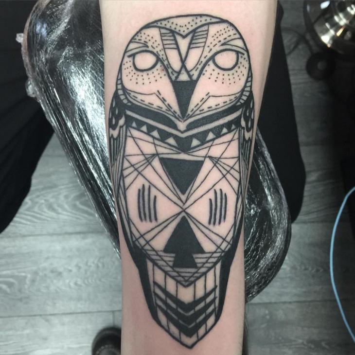geometric owl tattoo on forearm