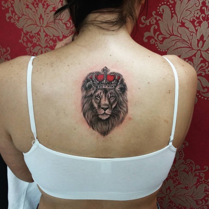 small lion tattoo on back