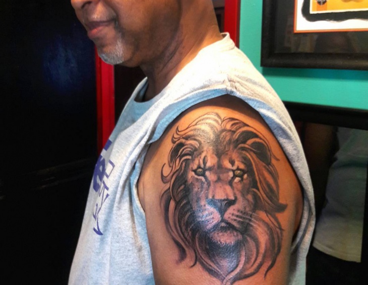 lion upper arm tattoo