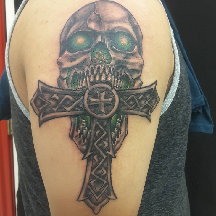upper arm cross tattoo