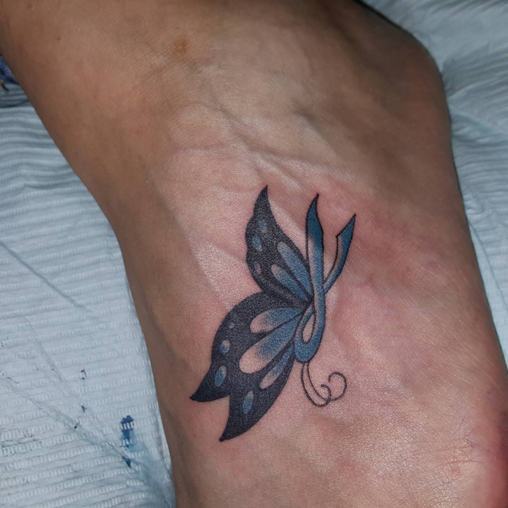 small butterfly tattoo design on foot