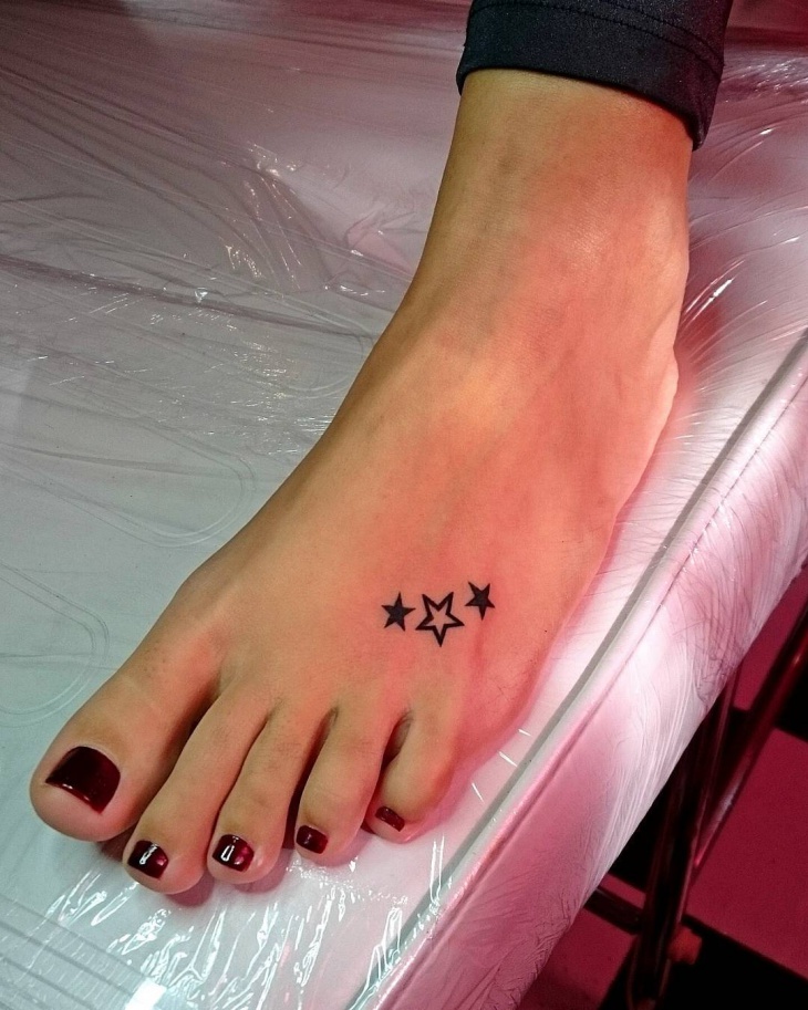 small star foot tattoo for women
