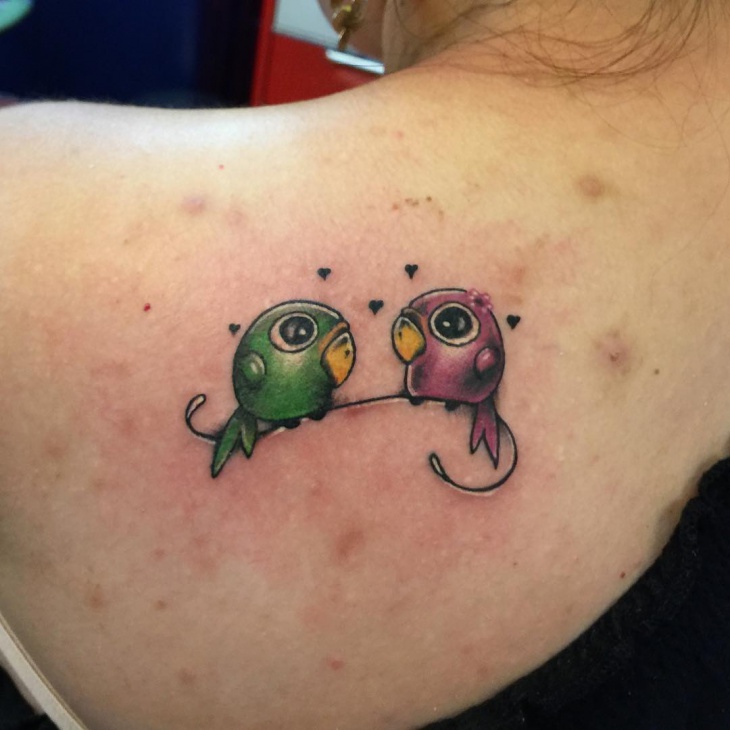 small bird tattoo on shoulder