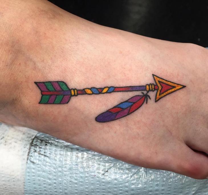 small arrow tattoo on foot