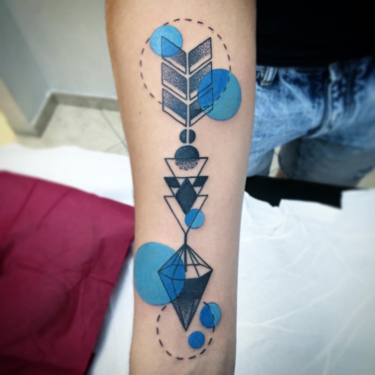 geometric arrow tattoo design on wrist