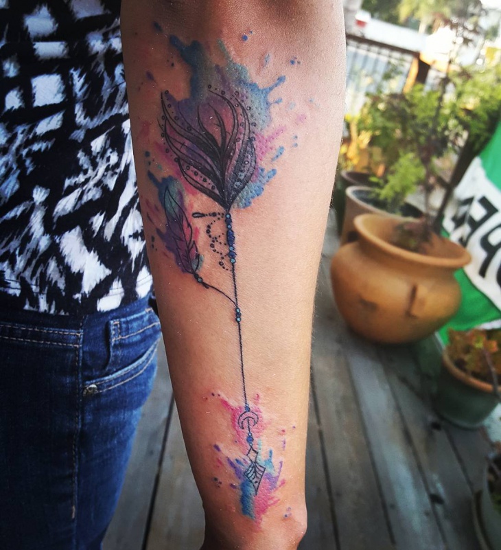 watercolor arrow tattoo on hand