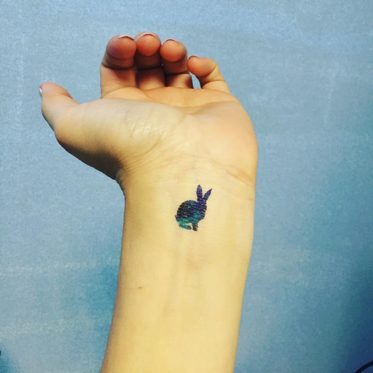 small rabbit tattoo on wrist 