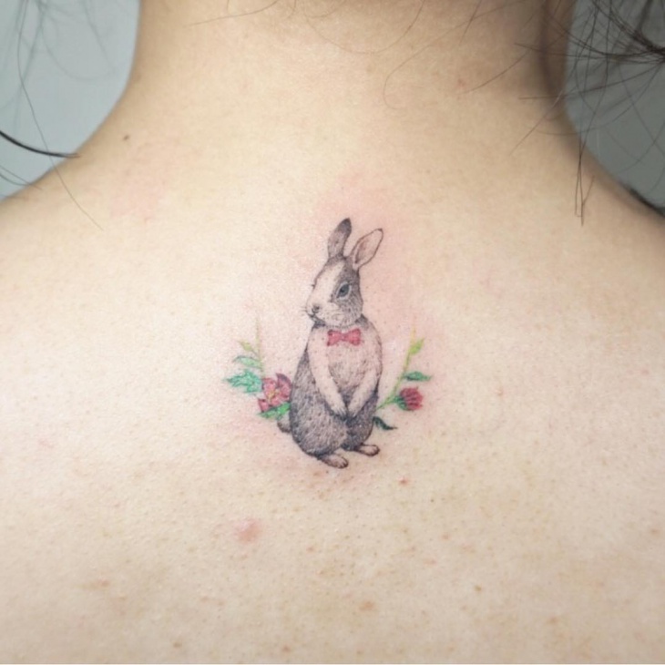 lovely rabbit tattoo on below neck