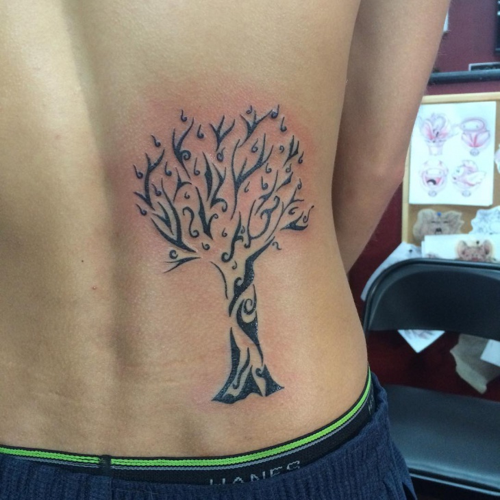 tribal tree tattoo on hip