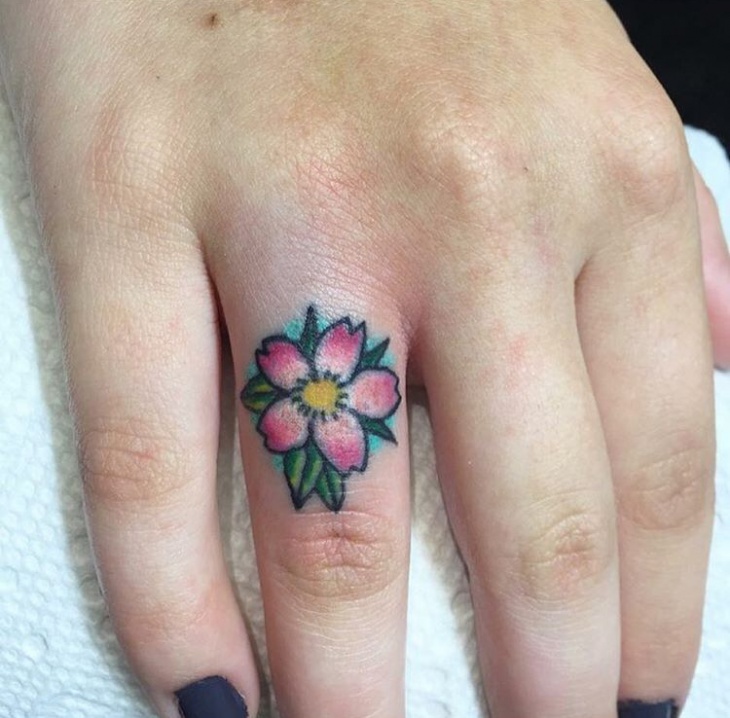 flower ring finger tattoo