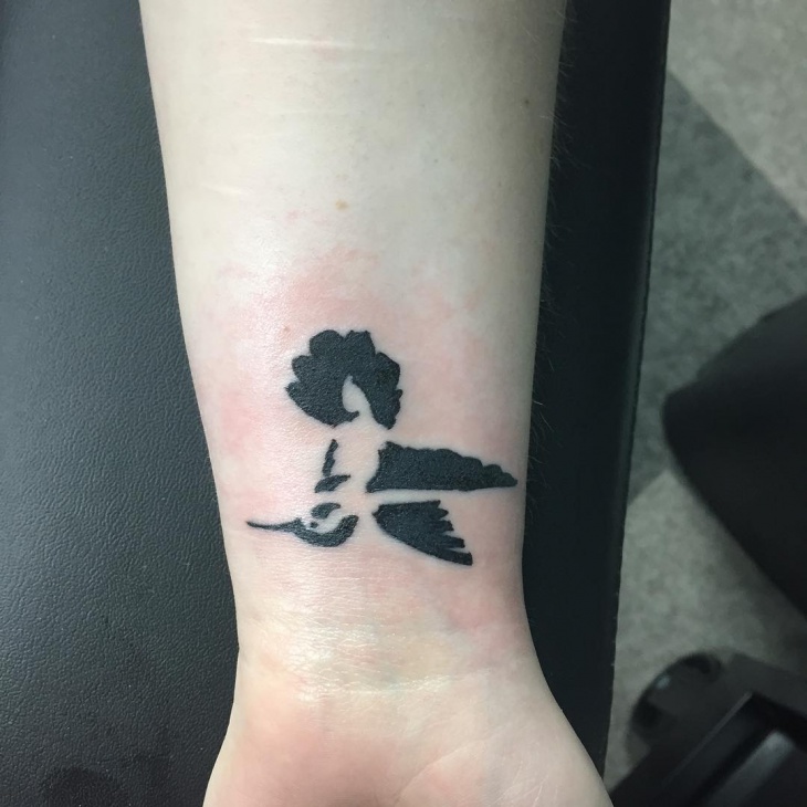 black bird tattoo on wrist