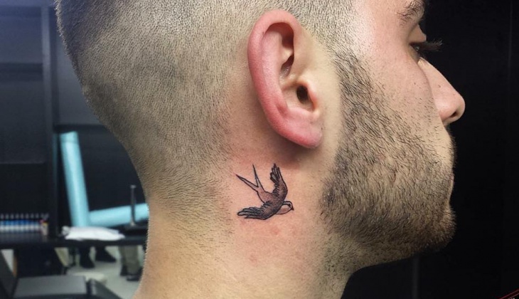 small bird tattoo design on neck