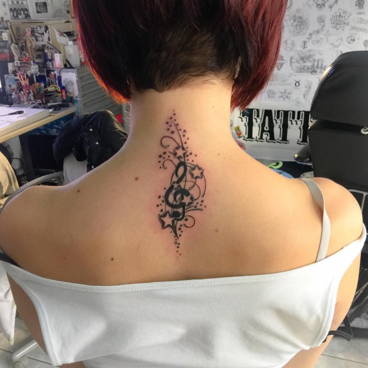 stars and swirls tattoo on back