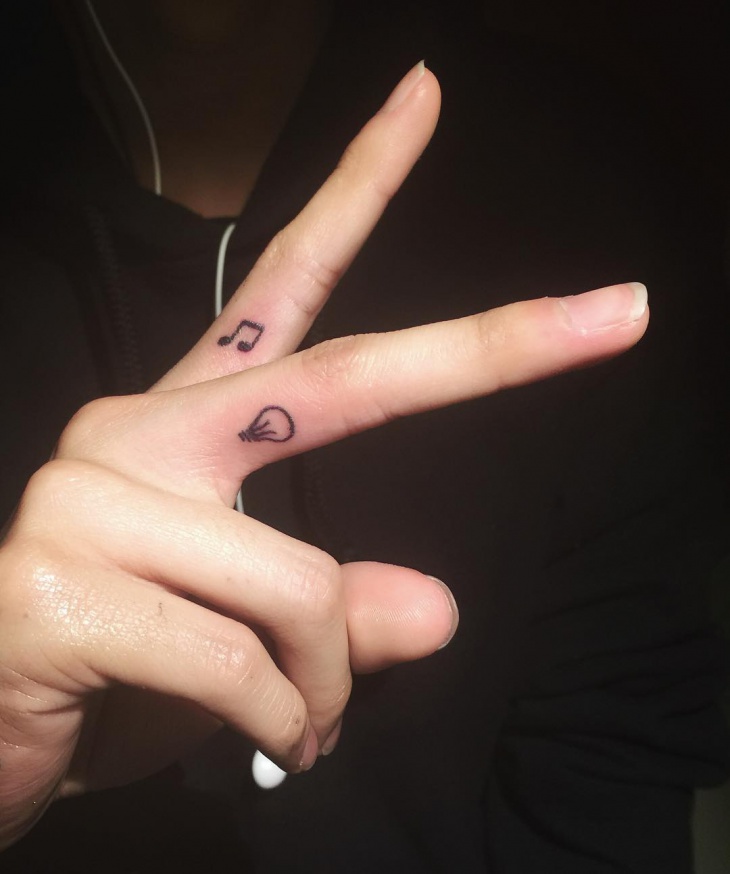 small music tattoo on finger