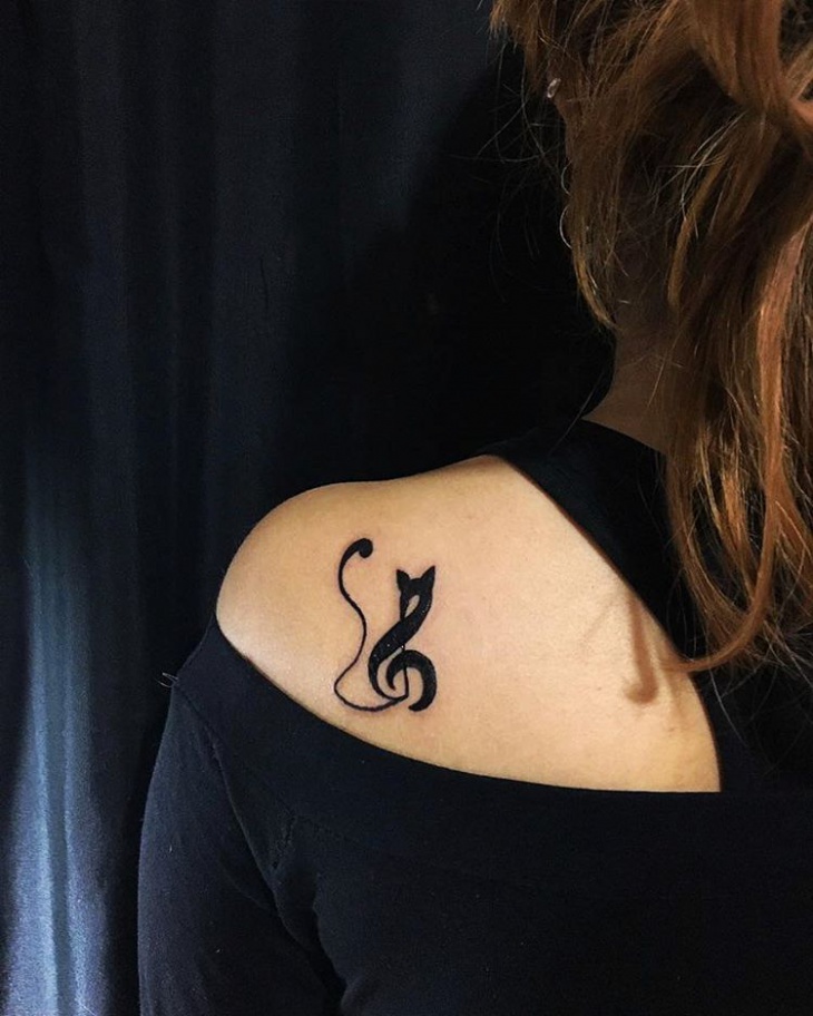 small music tattoo on shoulder