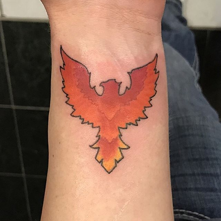 small phoenix tattoo on wrist