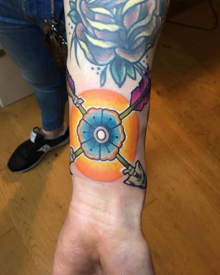 geometric flower tattoo on wrist