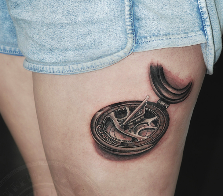 tribal compass tattoo on leg
