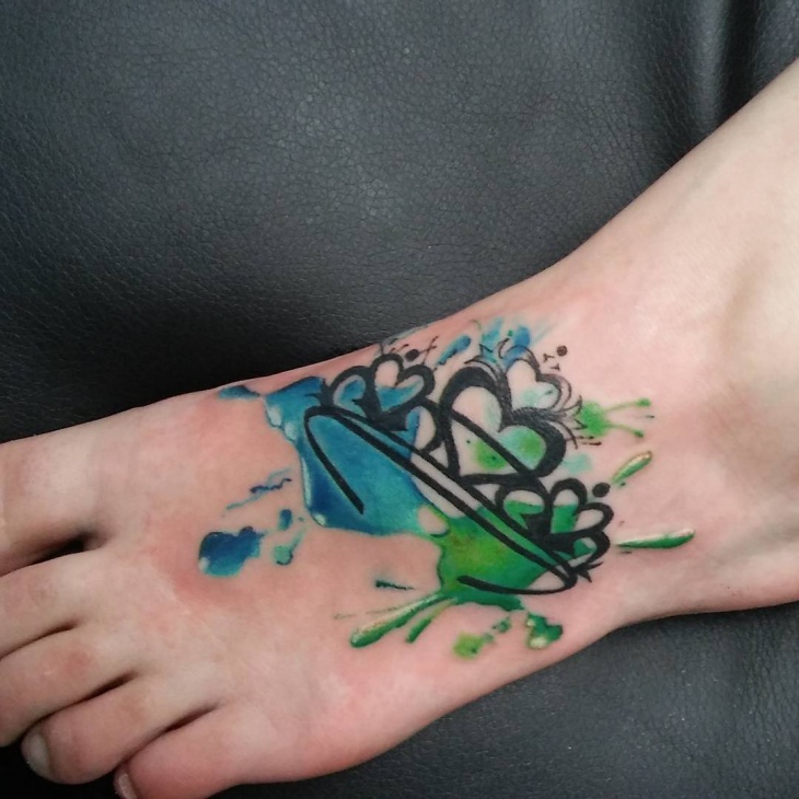 watercolor crown foot tattoo