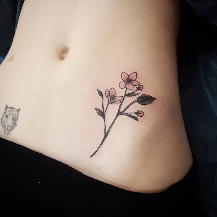 small flower stomach tattoo