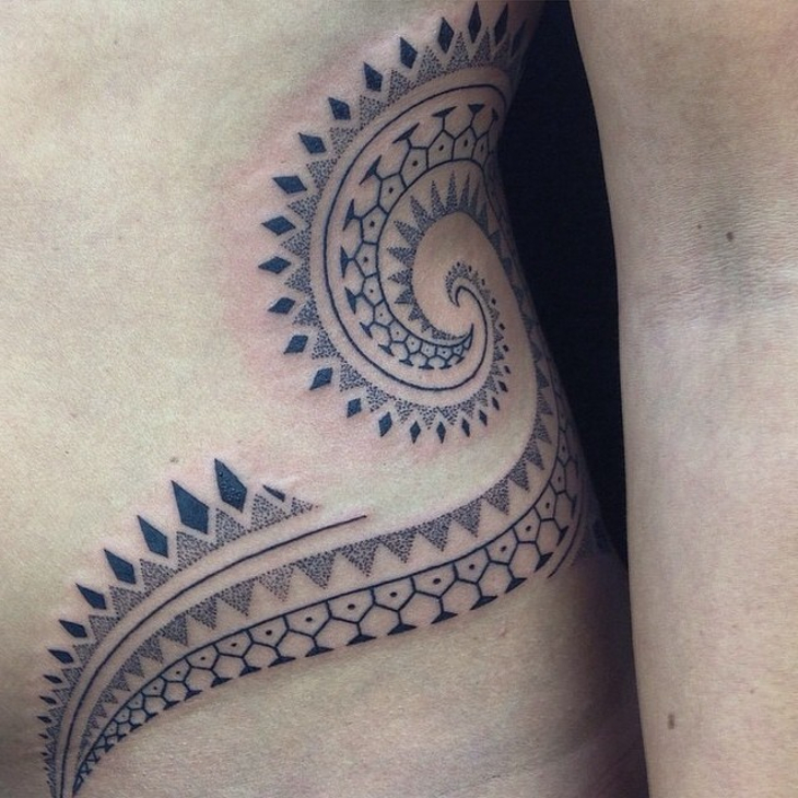 tribal side stomach tattoo