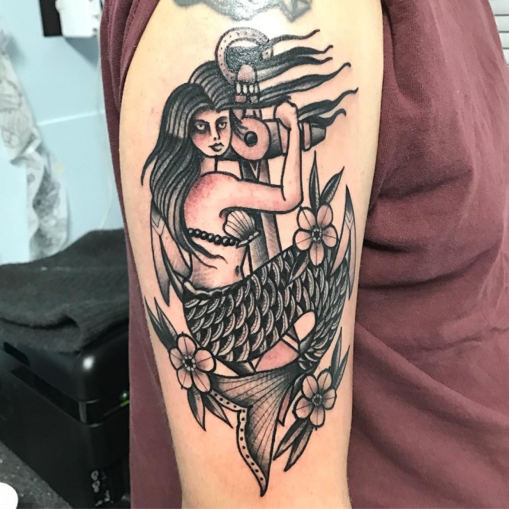 black work mermaid arm tattoo