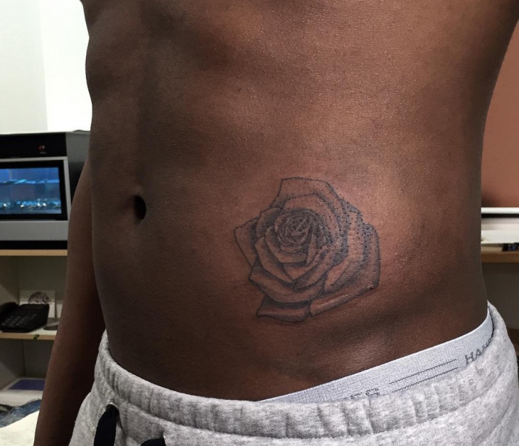 rose side stomach tattoo