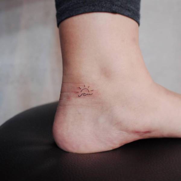 small sun tattoo on ankle