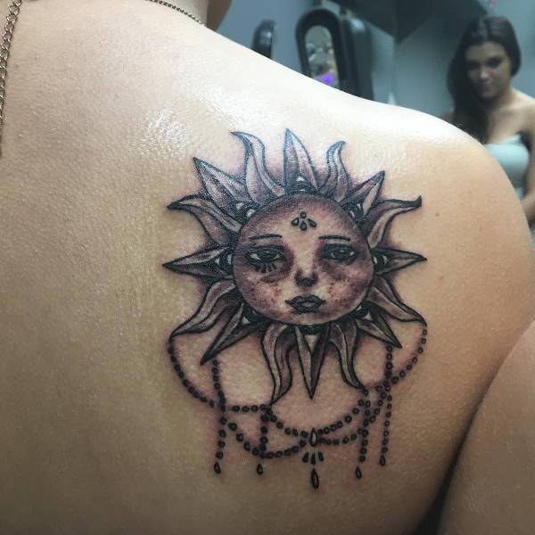vintage sun tattoo on shoulder