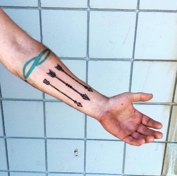 archery tattoo design on wrist