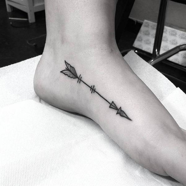 archery tattoo on foot