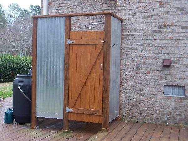rustic outdoor shower with wood door
